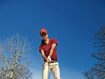At the Fresh Pond Golf Course in  Cambridge, Emily Balmert ’09 of the women’s golf team—the first Harvard woman to win the Ivy championship—swings into spring.