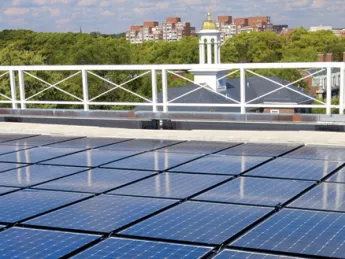 Harvard is already trying many green initiatives; it will need to do much more to meet its new greenhouse-gas emissions goal. Above: solar panels on the roof of the Business School’s Shad Hall.