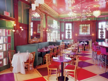 Linger at lunch in UpStairs on the Square’s festive “Monday Club Bar” section.