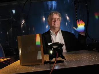Instrument designer Andrew Szentgyorgyi illustrates the prism technology for the GMT’s high-resolution spectrograph.