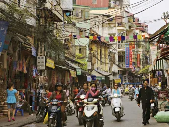 Hanoi&rsquo;s streets (in 2007, above) are now full of motorcycles and scooters, and shop shelves are no longer bare.