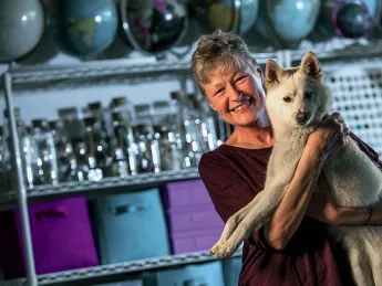 Linnea Olson, shown with her dog, Kumo, has survived 13 years with lung cancer.