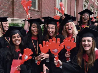 Harvard students in caps and gowns enjoying Commencement 