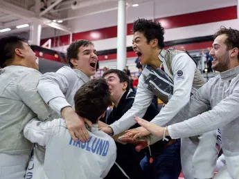 fencers celebrate a championship win