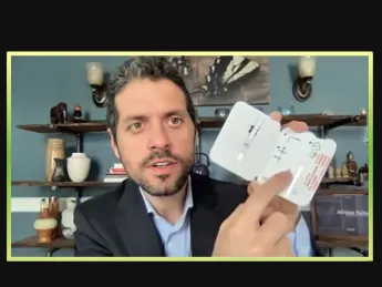 Michael Mina holds up a rapid test during a Zoom call with journalists.