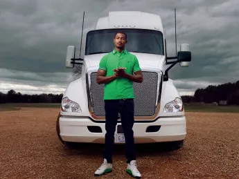 Photograph of Gary Jones standing in front of a tractor trailer truck
