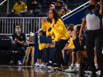 Carrie Moore on the sideline of a basketball game.