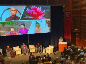 Alia Crum presents about mindfulness in allergy oral immunotherapy. Thich Nhat Hanh is on the top left of the slide. 