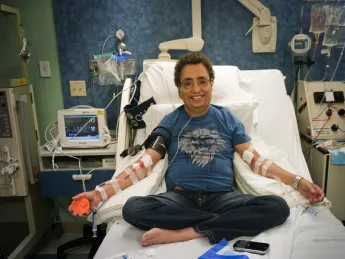 All in a day’s treatment: Khaled, seen in these photographs with hemapheresis practitioner Beverly Gedutis, R.N., and author David Nathan, spent May 8 at Children’s Hospital Boston, where for decades he has been transfused with red blood cells every three weeks. The bottles he carries below contain the iron chelator deferisirox.