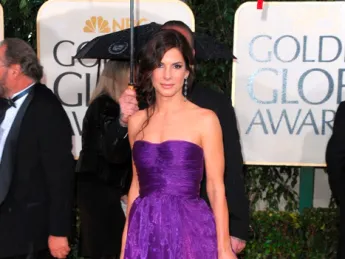 Sandra Bullock arrives at the 2010 Golden Globe Awards in a violet Bottega Veneta gown.