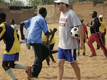 Nick Gates ’91, who founded Coaches Across Continents, works with coaches (above) and youths (at right) in Tanzania in 2009. 