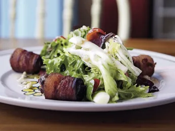 Tangy greens with bacon-wrapped dates