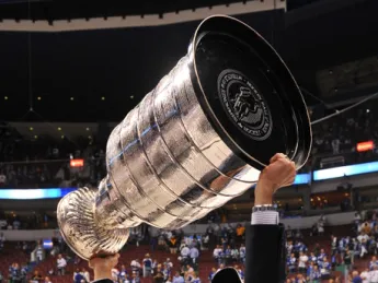 The Bruins' Don Sweeney '88 hoists the Stanley Cup.