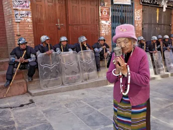 A Tibetan woman praying at the Boudhanath Stupa, near Kathmandu
