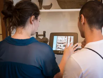 Brianna Macgregor '16 and Ozdemir Vayisoglu '16, both fellows at the Summer Humanities and Arts Research Program, digitally access information about an object at the Peabody Essex Museum (PEM) in Salem, Massachusetts, during a workshop on cultural interpretation. 