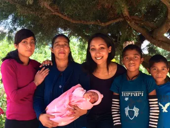 Global Health Equity Option Scholar Hanna Amanuel '16 (center) with a local family in Sierra Madre de Chiapas, Mexico. Amanuel spent this spring semester working with Compañeros En Salud México, Partners in Health's sister organization in Chiapas, as part of a new study-abroad program.