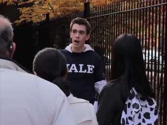 Samuel Clark, in costume, shows real tourists around Yale. He later said he was trying to be helpful.