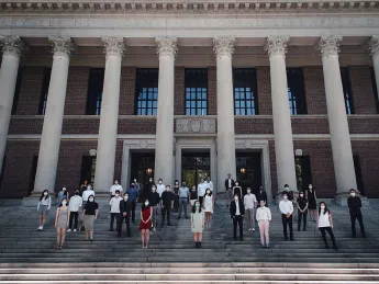 Group of degree candidates from the Design School pose on the steps of Widener for an unofficial Class Day photo.