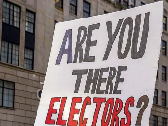 Protestors with a large poster demanding reform of the Electoral College