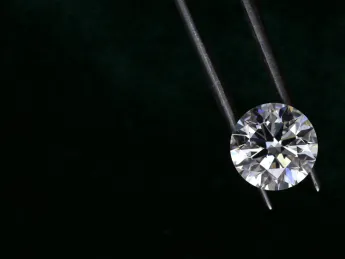 Diamond held by metal tongs