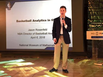 Jason Rosenfeld delivers a presentation with microphone in hand