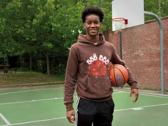 Ibrahim Barry with a basketball on a court