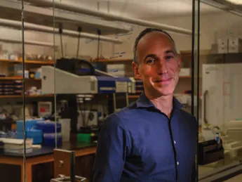 David Reich standing in his Harvard Medical School laboratory