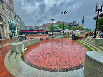 A red brick sunken pit in a plaza.
