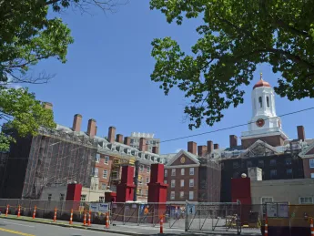 View of Dunster House, the first residence for upperclassmen to undergo full renewal, from Memorial Drive. Seven weeks after the reconstruction project began, Dunster is almost completely scaffolded, and its iron gate has been removed. 
