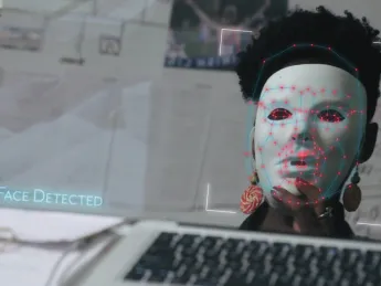Joy Buolamwini dons a white mask in order to be visible to facial recognition software in the film Coded Bias.