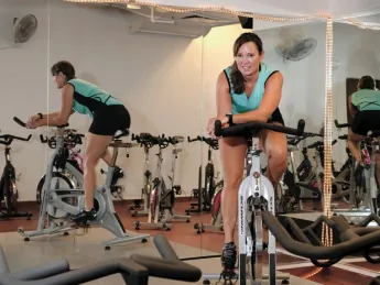 Murdock Stenis warms up for indoor cycling, an intense interval  workout with music.