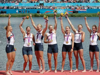 U.S. oarswomen Esther Lofgren ’09  (third from left ), who rowed in the #3 seat,  and Caryn Davies ’05 (second from right), who stroked the boat, celebrate with teammates after winning their Olympic gold medals.