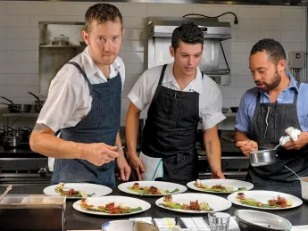 Chef/owner Alex Crabb shares the open kitchen with fellow cooks Tyson Wardwell and Nathan &ldquo;Lazer&rdquo; Phinisee.
