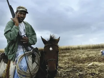 Scenes from <i>The Price of Sugar:</i> armed guards on horseback often patrol workers in shantytowns