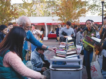 People perusing books outside at the Boston Book Festival 