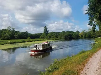 Michael Lyon and son ride a bike next to a river.