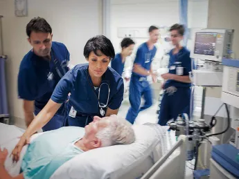 Stock photo, caring for patient in hospital bed