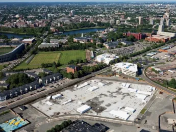 From a vantage point south of Western Avenue in Allston, looking northeast toward Harvard Square, the unfinished science complex dominates the foreground. Beyond it lie athletic fields that may yield to expansion by the School of Public Health, the Graduate School of Education, or other academic enterprises. A business “enterprise research campus” is envisioned south of Western Avenue, across from the high-rise graduate-student housing at One Western Avenue.