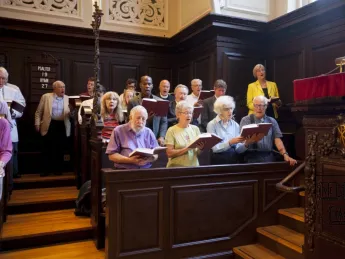 President Faust (standing at upper right, during the singing of Hymn 27) spoke at the first Morning Prayers of the new academic year.