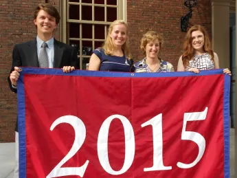 Holding their blue-trimmed class banner, sophomore class Undergraduate Council representatives Chris Smiles (at left) and Ryley Reynolds flank Catherine Katz ’13 and associate dean of Harvard College Joan Rouse. Katz first proposed a sophomore class event to administrators. Smiles and Reynolds are also members of the Harvard Alumni Association’s Building Community Committee. 