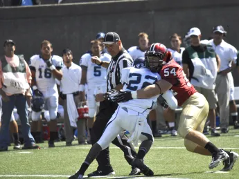 A not-quite-irresistible force meets an immovable object: Crimson linebacker Brian Reilly stopping San Diego tailback Kenn James in Saturday's Stadium opener. The visitors'  running backs netted just 35 yards rushing against a staunch Harvard defense.