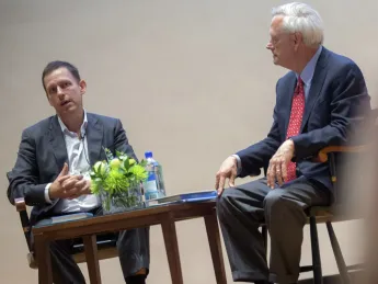 Entrepreneur Peter Thiel (left) and professor of business administration William A. Sahlman discuss the power of monopolies at an event in Burden Hall.
