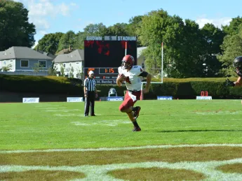 Pursued in vain by Brown's Will Twyman, Harvard quarterback Joe Viviano scampered for his second touchdown. 