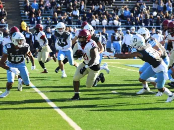 Running back Aidan Borguet runs up field through Columbia defenders.