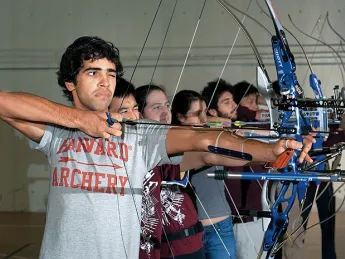 Samuel Saidel-Goley (foreground) and Archery Club colleagues draw their bows.