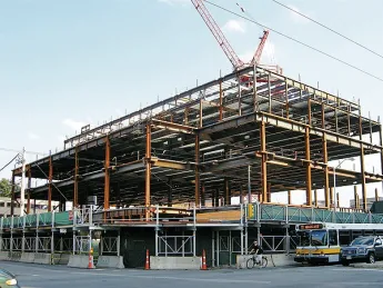 Structural steel is erected for the Law School’s Wasserstein Hall, Caspersen Student Center, and clinical-wing project on Massachusetts Avenue at Everett Street.