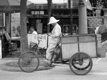 A texting break, in Shanghai. Layers of tradition and modernity make it rewarding—and essential—to learn about China through its languages.