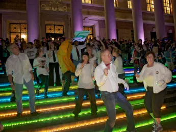 To get the evening's dancing started, a "flash mob" of dancers performed a choreographed routine they'd rehearsed throughout the previous week. The dancers were on the steps of Widener Library and at other Yard locations. Colorful LED lighting decorated buildings around the Yard.