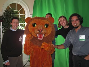 Graduate students pose with the Dudley Lion mascot.