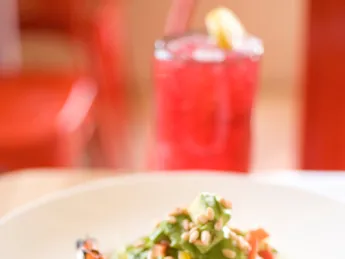 Grilled shrimp adds color to The Omega, a salad with avocado, corn, and cilantro.
